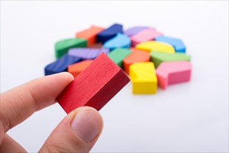 Colorful wooden pieces of a logic puzzle in hand