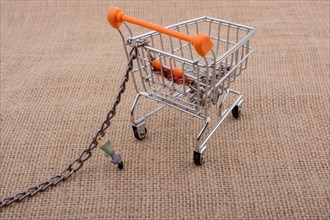 Woman figurine attached to a Shopping cart with chain