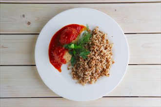 Traditional russian meatballs with buckwheat and tomato sauce