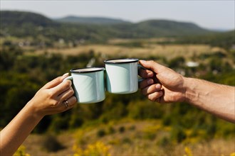 Couple toasting with cups coffee