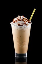 Caramel milkshake isolated on black background