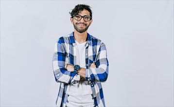 Friendly young man with crossed arms on isolated background. Teenage guy smiling with crossed arms isolated. Smiling bearded handsome man with crossed arms isolated