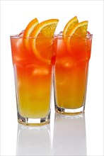 Two highball glasses with Juicy Orange and Red Tequila Sunrise cocktail with reflection isolated on white