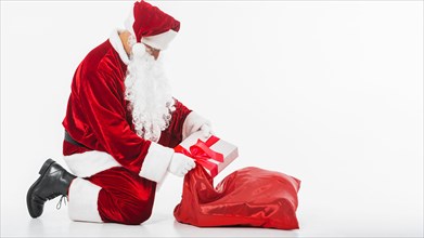 Santa claus putting gift box sack. Resolution and high quality beautiful photo