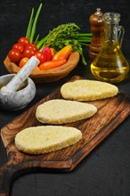 Semifinished homemade zander cutlet on a wooden serving board