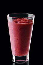 Glass of strawberry smoothie isolated on black background