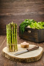Fresh asparagus on wooden cutting board