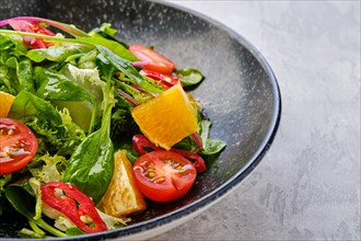 Closeup view of spicy salad with orange