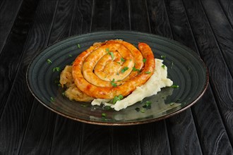 Fried homemade sausage with mashed potato and braised cabbage