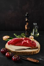 Raw top sirloin beef steak on wooden cutting board
