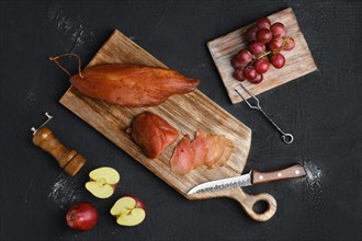 Air dried turkey ham on wooden cutting board
