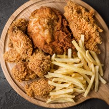 Top view fried chicken with fries cutting board. Resolution and high quality beautiful photo