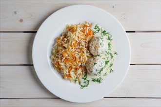 Top view of plate with meatballs with rice and carrot