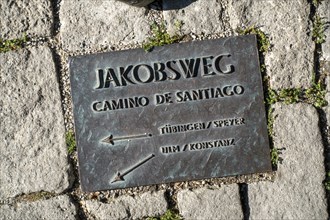 Ground plate embedded in the ground in front of the Protestant St. Jakob's Church on the Way of St. James to Santiago de Compostella