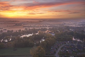 Aerial view of the landscape around Sandbraak Lake near Fuenfhausen in Hamburg's Kirchwerder district in autumnal morning atmosphere with light ground fog. In the foreground the residential area Fritz...