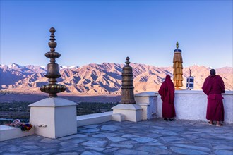 Two monks on the roof at Spituk Monastery
