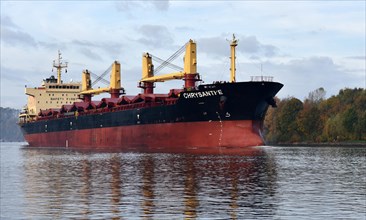 Cargo ship Chrysanthe sails through the Kiel Canal in autumn