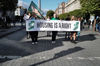 Three young Sinn Fein party supporters demand a better housing situation at a Cost of Living Protest. Dublin