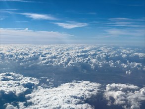 View from aeroplane of cluster clouds in foreground Altocumulus in background above Cirrocumulus clouds