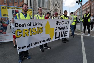 Protestors at a Cost of Living Crisis demonstration in Dublin city centre holding a banner. Dublin