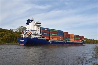 Container ship Sonderborg in autumn in the Kiel Canal