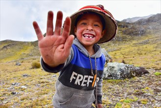 Running boy with traditional hat in the Andes