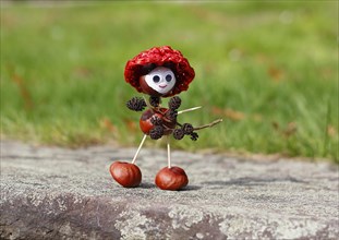 Chestnut figure with hat wearing black alder cones