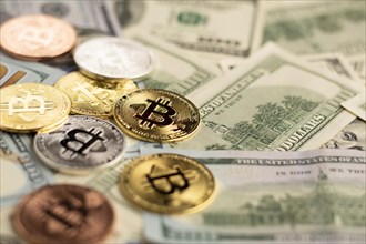Bitcoin above dollar bills close up