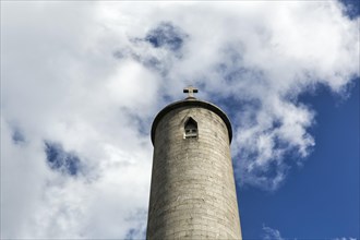 Round tower with stone cross