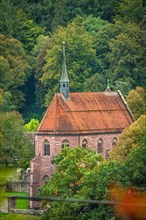 Monastery church in autumn forest