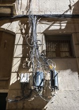 Power lines and cables on the house facade