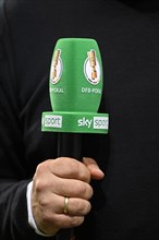 Hand holding microphone with logo DFB-Pokal