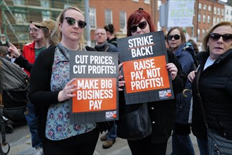 Protestors at a Cost of Living Protest holding two placards in protest at rising prices. Dublin