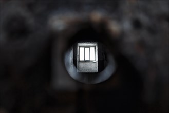 View through peephole into dark prison cell
