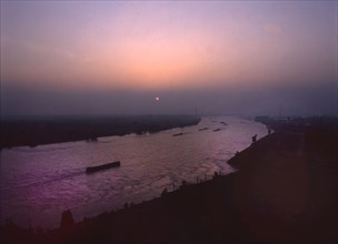 Port and industrial facilities at sunset in 1990. Duisburg. View of the Rhine from the Thyssen Krupp skyscraper