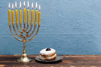 Jewish menorah with tasty donut