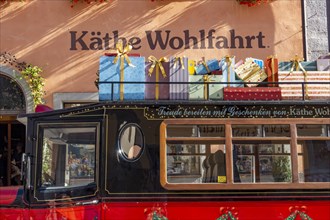 Decorated vintage bus with gift packages on the roof in front of the house of Kaethe Wohlfahrt Weihnachtsdorf
