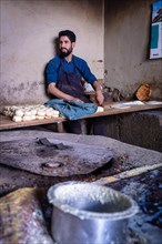A man preparing dough for bread in Leh