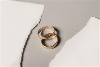 Broken paper with golden wedding rings