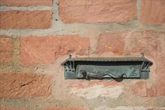 Letterbox with lizard figure and house number 2
