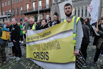 Protestors at a Cost of Living Crisis demonstration in Dublin city centre holding a banner. Dublin