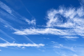 Blue sky with Cirrus feather clouds on the left Cirrocumulus cluster clouds on the right