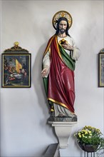 Christ figure with floral decoration