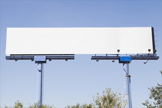 Big blank advertising hoarding against blue background