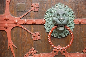 Fittings with lion's head and door knocker ring on the church door of St. Valentinus and Dionysius