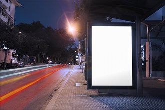 Blank billboard bus stop night with lights cars passing by