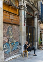 Graffiti on the blinds of vacant shops in the old town of Barcelona