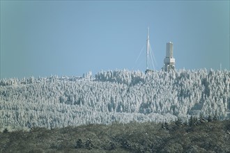 View of Grosser Feldberg with broadcasting tower in winter landscape