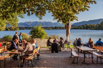 Beer garden at Staffelsee with Ester Mountains in the evening sun