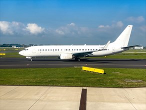 White painted aircraft without logo jet passenger aircraft Jet Boeing 737 86J D-ABBD year of construction 2002 in waiting position on taxiway taxiway in front of takeoff takeoff at Duesseldorf Interna...